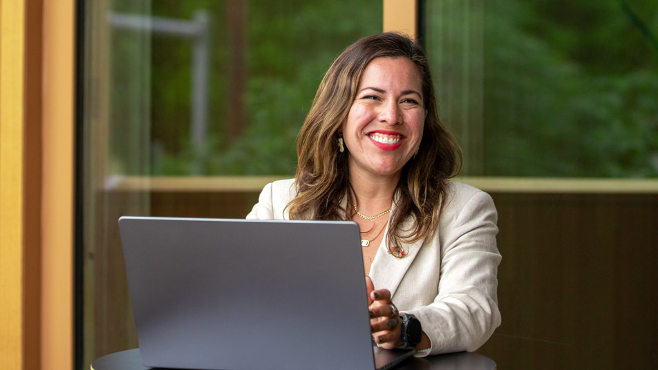 Carla Perscky smiling on her laptop