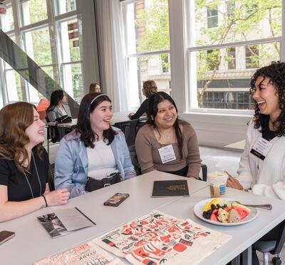 OSU alumns laughing around a table